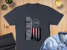 Load image into Gallery viewer, Dark gray t-shirt with distressed "WE THE PEOPLE" and flag design.
