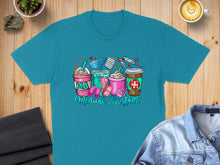 Load image into Gallery viewer, Teal t-shirt with coffee cups, medical icons, and "MA Medical Assistant" text.
