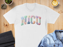 Load image into Gallery viewer, White t-shirt with "NICU" spelled out in colorful, patterned patches.
