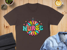 Load image into Gallery viewer, Brown t-shirt with "Nurse" in colorful floral lettering, stethoscope accent.
