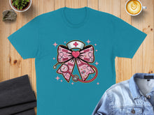 Load image into Gallery viewer, Teal t-shirt with stethoscope, nurse cap, and XOXO bow graphic.
