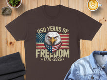 Load image into Gallery viewer, Brown t-shirt with eagle, American flag bandana, and "250 Years of Freedom 1776-2026" text.
