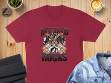 Load image into Gallery viewer, Burgundy t-shirt with "MY DAD ROCKS" and two guitars graphic.
