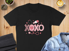 Load image into Gallery viewer, Black t-shirt with pink "XOXO" design featuring stethoscope and pill graphic.
