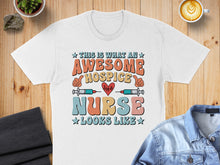 Load image into Gallery viewer, Awesome hospice nurse shirt with colorful text and heart monitor graphic.
