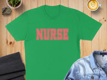 Load image into Gallery viewer, Green t-shirt with "NURSE" in coral lettering, laid flat with denim jacket and coffee.
