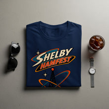 Load image into Gallery viewer, Navy t-shirt with "Shelby Hamfest" text, radio tower, and orbital rings graphic.
