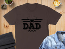 Load image into Gallery viewer, Brown t-shirt with a black "Dad" graphic featuring stars and wings.
