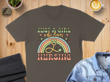 Load image into Gallery viewer, "Just a girl who loves nursing" text with stethoscope rainbow and syringes design on a brown t-shirt.
