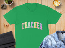 Load image into Gallery viewer, Green t-shirt with pastel "TEACHER" text arched across chest.
