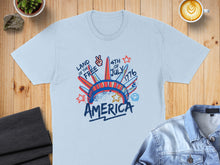 Load image into Gallery viewer, Light blue t-shirt with "Land of the Free 4th of July America" graphic.
