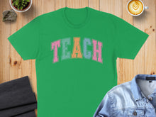 Load image into Gallery viewer, Green t-shirt with "TEACH" in colorful block letters.
