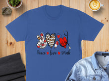 Load image into Gallery viewer, Blue t-shirt with peace sign, leopard print heart, and stethoscope graphic.
