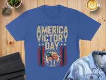 Load image into Gallery viewer, Blue t-shirt with "America Victory Day" and US flag graphic.
