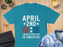 Load image into Gallery viewer, Teal t-shirt with "April 2nd Liberation Day in America!" text and flag design.
