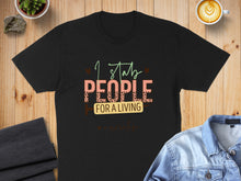 Load image into Gallery viewer, Black t-shirt with "I stab people for a living" text and "Nurse life" accent.
