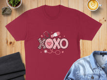 Load image into Gallery viewer, Burgundy t-shirt with XOXO design featuring hearts, stethoscope, and pills.
