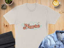 Load image into Gallery viewer, Light tan t-shirt with "Nurse" text and teal heart and stethoscope graphic.
