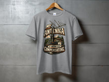 Load image into Gallery viewer, Grey t-shirt with "My Antenna Is Definitely Compensating" graphic.
