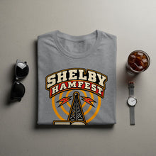 Load image into Gallery viewer, Grey t-shirt with Shelby Hamfest logo featuring a radio tower and lightning bolts.
