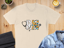 Load image into Gallery viewer, Cream t-shirt with Halloween-themed "RN" graphic featuring a stethoscope, eyes, and spiders.

