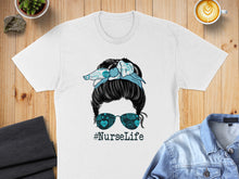 Load image into Gallery viewer, T-shirt with messy bun, bandana, and "#NurseLife" graphic on sunglasses.

