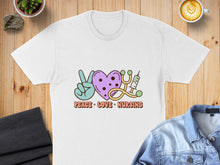 Load image into Gallery viewer, White t-shirt with "Peace, Love, Nursing" text and heart, peace sign, and stethoscope graphic.
