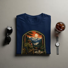 Load image into Gallery viewer, Navy t-shirt with graphic of man using radio in mountain landscape.
