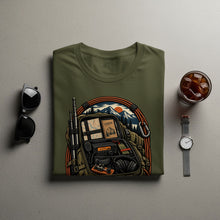 Load image into Gallery viewer, Olive green t-shirt with graphic of backpack containing radio, headphones, and logbook.
