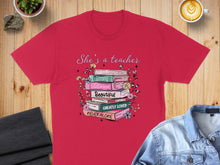 Load image into Gallery viewer, Red t-shirt with text "She's a teacher" and stacked books with inspirational words.
