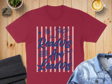 Load image into Gallery viewer, Maroon t-shirt with blue text "Readers Are Leaders" on striped background.
