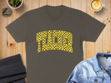 Load image into Gallery viewer, Brown t-shirt with "TEACHER" in a yellow and black checkerboard pattern.
