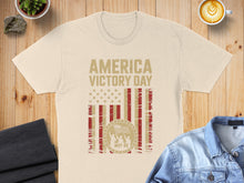 Load image into Gallery viewer, Cream t-shirt with "America Victory Day May 08" and US flag design.
