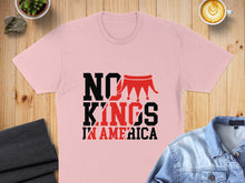 Load image into Gallery viewer, Light pink t-shirt with "NO KINGS IN AMERICA" text and crown graphic.

