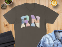 Load image into Gallery viewer, Brown t-shirt with patchwork "RN" letters on a wooden surface.
