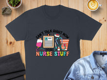Load image into Gallery viewer, Dark t-shirt with "Can't Talk Right Now Doing Nurse Stuff" text and medical icons.
