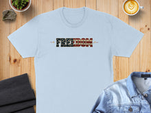 Load image into Gallery viewer, Light blue t-shirt with "FREEDOM" in flag-like lettering.
