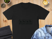 Load image into Gallery viewer, Black t-shirt with "Te Ac H Er the inspirational element" in periodic table style.
