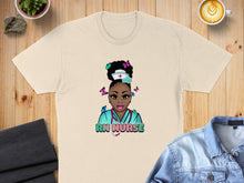 Load image into Gallery viewer, Cream t-shirt featuring cartoon nurse with butterflies and "RN NURSE" text.
