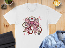 Load image into Gallery viewer, Pink stethoscope, nurse hat, and "XOXO" pattern on a white t-shirt.
