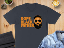Load image into Gallery viewer, Dark grey t-shirt with orange text "Dope. Black. Father." and man's portrait.
