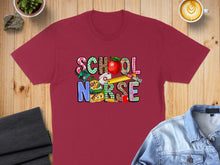 Load image into Gallery viewer, Maroon t-shirt with "SCHOOL NURSE" text in colorful, patterned letters and school-themed graphics.
