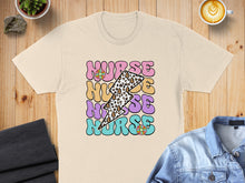 Load image into Gallery viewer, T-shirt with "Nurse" text in colorful, groovy font with lightning bolt and floral accents.

