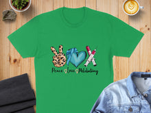 Load image into Gallery viewer, Green t-shirt with peace sign, heart, and syringes graphic reading "Peace Love Phlebotomy."
