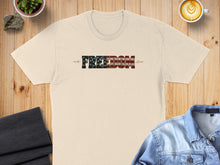 Load image into Gallery viewer, Cream t-shirt with "FREEDOM" text in American flag pattern.

