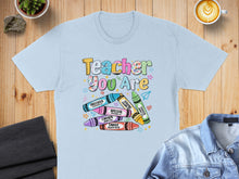 Load image into Gallery viewer, Light blue t-shirt with colorful crayons and text "Teacher You Are" and Bible verses.
