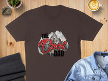 Load image into Gallery viewer, Brown t-shirt with "The Cool Dad" text and mountain graphic.
