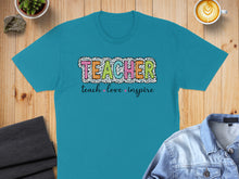 Load image into Gallery viewer, Teal t-shirt with "TEACHER" in colorful animal print font and "teach love inspire" below.

