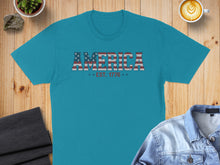 Load image into Gallery viewer, Turquoise t-shirt with "AMERICA EST. 1776" text in distressed American flag design.
