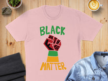 Load image into Gallery viewer, Pink t-shirt with Black Lives Matter fist graphic and green, yellow, red stripes.

